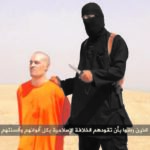 US journalist Steven Sotloff kneeling next to a masked Islamic State fighter, known as 'Jihadi John.