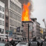 Explosion brings down building, inflicts injuries; cause being investigated but appears gas-related
