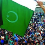 A masked man waves Pakistan flag at a rally to welcome All India Hurriyat Conference leader Syed Ali Shah Geelani on his arrival in Srinagar from Delhi. - Photo courtesy PTI