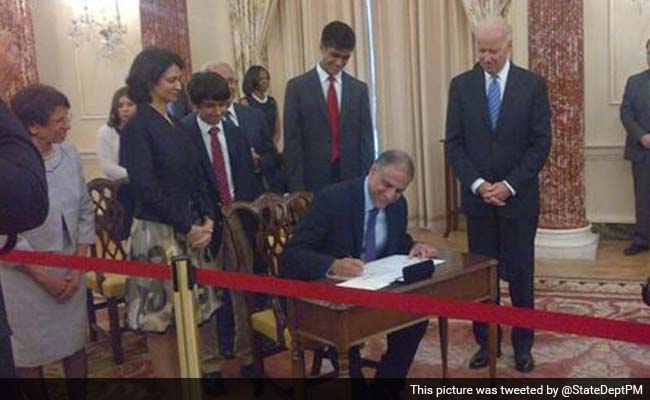 Indian-American Diplomat Puneet Talwar (sitting) sworn in as US Assistant Secretary for Bureau of Political-Military Affairs by US Vice President Joe Biden