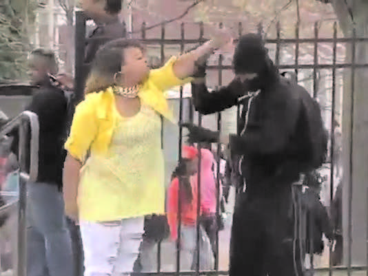 Graham is seen pulling her masked son away from a protest crowd