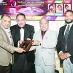 Chief Guest Nasir Mehmood is receiving Unity Award . Others in the picture- President O.S. Modgil, and Noor Amrohvi