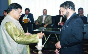 Community activist Pervaiz Alam and poet and Chief Organizer Noor Amrohvi lighting the candle to inaugurate the Mushaira