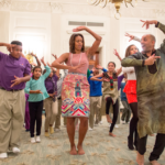 Michelle Obama tries out traditional dance moves, led by Nakul Dev Mahajan, a choreographer of the TV show So You Think You Can Dance.