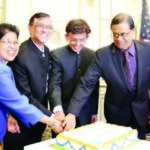 Celebrating India's birthday. India's Consul General Dnyaneshwar M Mulay (second from left) cuts the cake