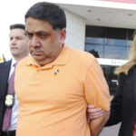Harendra Singh is led out of the FBI office in Melville early Wednesday