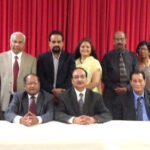 Attached photo: Immigration panelists with organizers. From l. to r. in the front row: Sudha Acharya, Dr. Thomas Abraham, Anand Ahuja, Michael Phulwani, David Nachman and Inderjit Singh