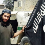 Abdel-hamid Abaaoud holding the Quran & the ISIS Flag
