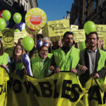 Greenpeace activists, demanding 100% renewable energy at Climate March 2015 in Madrid.