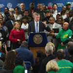 New York City Mayor Bill de Blasio announced, January 6, guaranteed $15 minimum wage for all City government employees. Council Speaker Mark Viverito is seen to the right of the Mayor Photo courtesy Mayor's Office