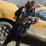 Suspected ISIS terrorist Abu Rumaysah, who was born as Siddhartha Dhar holding his newborn son in one hand and an AK-47 assault rifle in the other. (File Photo)