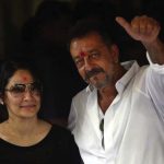 Sanjay Dutt, right, shows a thumbs up sign along with his wife Maanyata after arriving at his residence in Mumbai. Photo courtesy: AP