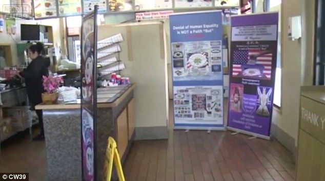 The signs inside the shop (pictured) criticize several religions and display several emblems such as a Confederate flag, a Star of David and a Christian cross