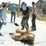 An Indian soldier being beaten with sticks by goons in Kashmir