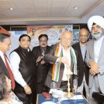 Shinde lighting a lamp. From L to R- Harbachan Singh, Sangat Singh, Devendra Vora, Sushil Kumar Shinde, George Abraham, Mohinder Singh Gilzian (Photo : INOC, USA)