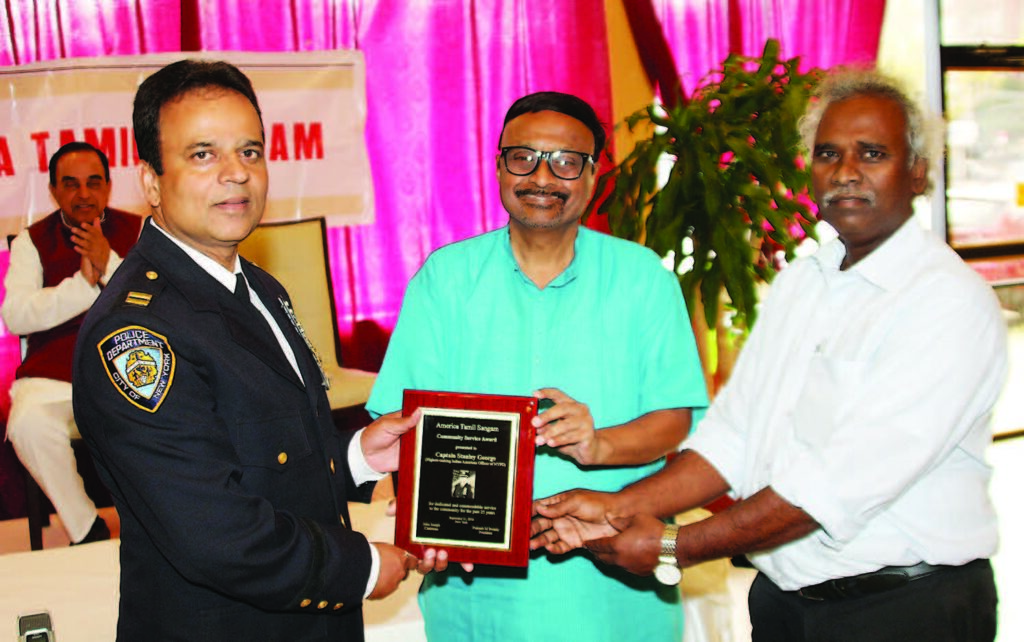Prakash M Swamy, president and John Joseph, Chairman of the Sangam present the award to Capt. Stanley George