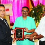Prakash M Swamy, president and John Joseph, Chairman of the Sangam present the award to Capt. Stanley George