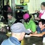 Police Captain Rachel Evans, volunteers to serve food to the poor at a facility run by Mother Teresa's sisters in New York's South Bronx