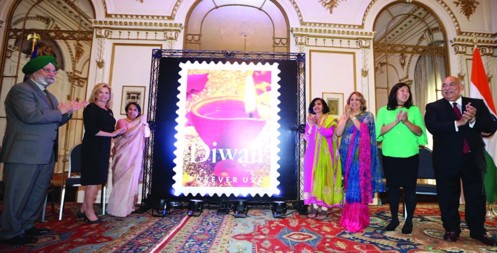 USPS organized a special function to unveil the Diwali Stamp at the Consulate General of India in New York, October 5. Seen in the picture at the ceremony (from L to R): Ambassador Hardeep S Puri, Congresswoman Carolyn Maloney, Consul General Riva Ganguly Das, U.S. Postal Service Vice-President of Mail Entry and Payment Technology Pritha Mehra, Chair, Diwali Stamp Project Ranju Batra, Congresswoman Grace Meng, Emcee of the event Ravi Batra Photos / Mohammed Jaffer-SnapsIndia