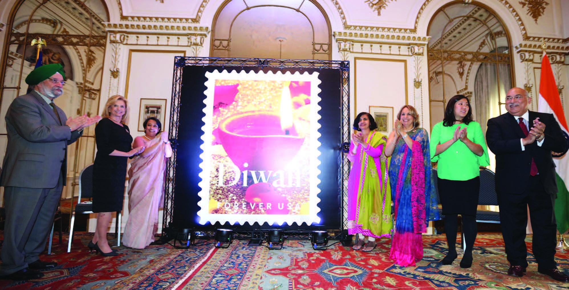 USPS organized a special function to unveil the Diwali Stamp at the Consulate General of India in New York, October 5. Seen in the picture at the ceremony (from L to R): Ambassador Hardeep S Puri, Congresswoman Carolyn Maloney, Consul General Riva Ganguly Das, U.S. Postal Service Vice-President of Mail Entry and Payment Technology Pritha Mehra, Chair, Diwali Stamp Project Ranju Batra, Congresswoman Grace Meng, Emcee of the event Ravi Batra Photos / Mohammed Jaffer-SnapsIndia