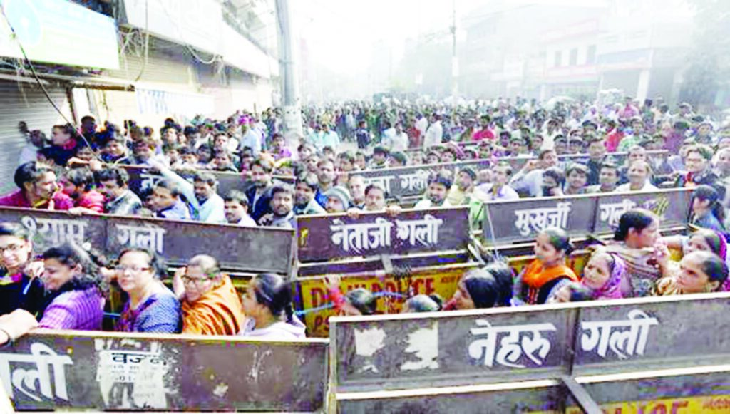 People line up outside State Bank of India to deposit and exchange banned currency notes for new ones at Gandhi Nagar in New Delhi.