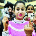 A girl, along with her family members, showing indelible ink mark on her finger after casting vote during the assembly election at a polling station in Patiala on February 4. Photo courtesy/ PTI