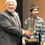 Brain Bee founder Norbert Myslinski, PhD, associate professor at the University of Maryland School of Dentistry, presents a trophy to 2017 USA champion Sojas Wagle