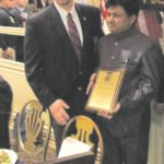 Dhiren Amin with his award. To his right is Michael Manzo.