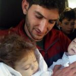 In this picture taken on Tuesday April 4, 2017, Abdel Hameed Alyousef holds his twin babies who were killed during a suspected chemical weapons attack