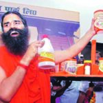 Baba Ramdev displays Patanjali products (Inset a bottle of rejected Amla juice)