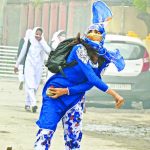 A girl student pelts a stone at security personnel during clashes near Lal Chowk in Srinagar. Photo courtesy: PTI