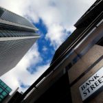 A sign for Bank Street and high rise offices are seen in the financial district in Canary Wharf in London, Britain, October 21, 2010. REUTERS/Luke Macgregor/File Photo