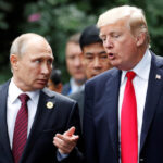 U.S. President Donald Trump and Russia’s President Vladimir Putin talk during the family photo session at the APEC Summit in Danang, Vietnam