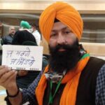 A farmer at the meeting displays the resolve of farmers Either will win or die