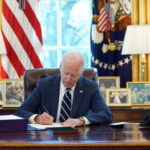 Biden in Oval office signs Rescue Plan