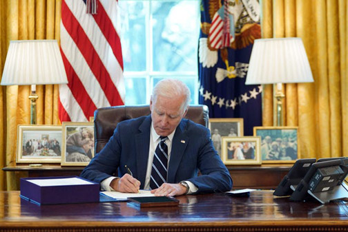 Biden in Oval office signs Rescue Plan