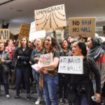 Demonstrators yell slogans during second day of anti-Donald Trump immigration ban protests inside Terminal 4 at San Francisco International Airport in San Francisco