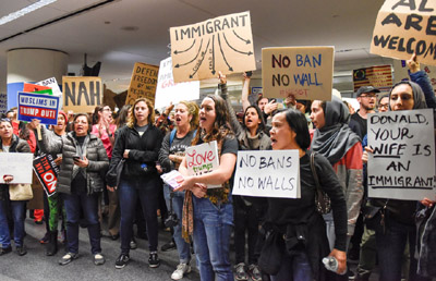 Demonstrators yell slogans during second day of anti-Donald Trump immigration ban protests inside Terminal 4 at San Francisco International Airport in San Francisco