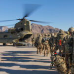 Soldiers attached to the 101st Resolute Support Sustainment Brigade, Iowa National Guard and 10th Mountain, 2-14 Infantry Battalion, load onto a Chinook helicopter to head out on a mission in Afghanistan