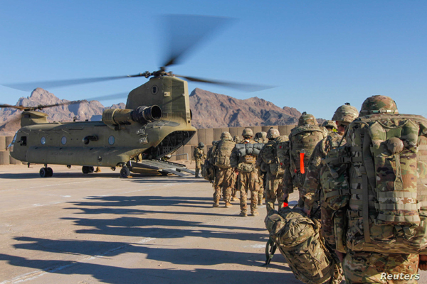 Soldiers attached to the 101st Resolute Support Sustainment Brigade, Iowa National Guard and 10th Mountain, 2-14 Infantry Battalion, load onto a Chinook helicopter to head out on a mission in Afghanistan
