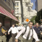 People run for life after the World Trade Center Twin Towers were struck