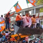 Bjp workers atop a buldozer