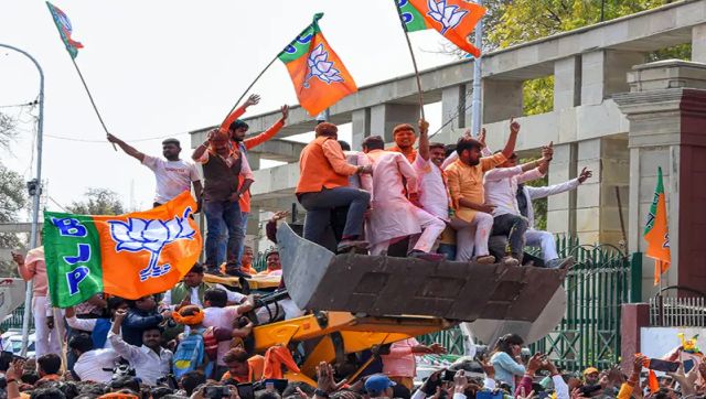 Bjp workers atop a buldozer